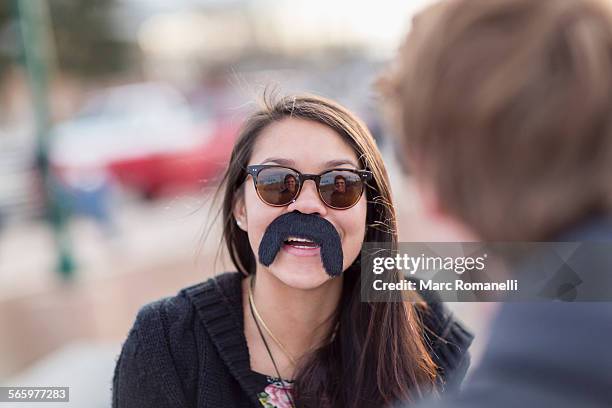 teenage girl wearing fake mustache - fake of indian girls - fotografias e filmes do acervo