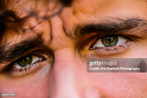 close up of eyes of hispanic man - angry eyes stock pictures, royalty-free photos & images