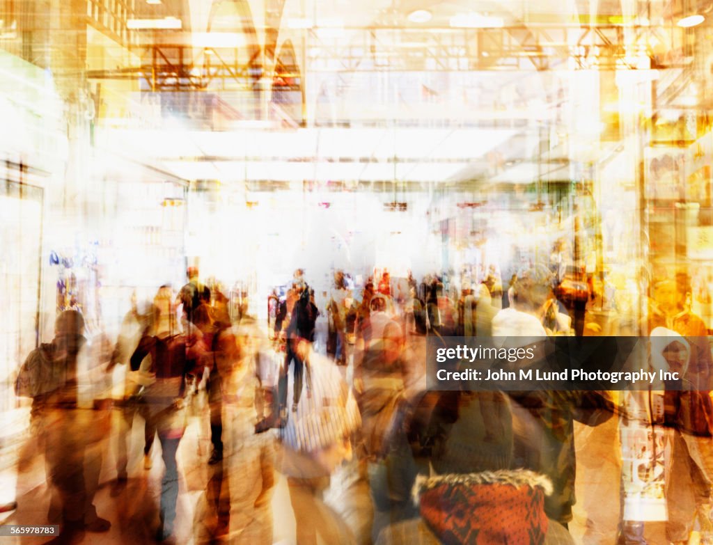 Blurred view of people walking in busy lobby