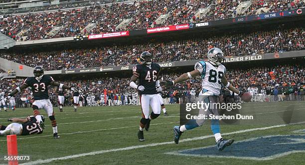 Wide receiver Steve Smith of the Carolina Panthers runs over the defenses Chris Harris of the Chicago Bears for a 58 yard touchdown on the opening...