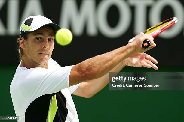 Gaston Gaudio of Argentina hits a backhand in his match against Razvan Sabau of Romania during day one of the Australian Open at Melbourne Park...