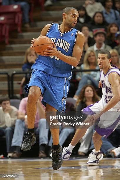 Grant Hill of the Orlando Magic looks to drive against the Sacramento Kings as Francisco Garcia of the Sacramento Kings looks on on January 15, 2006...