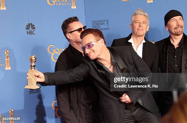 January 12, 2014 The group U2, Larry Mullen Jr., Bono, Adam Clayton and The Edge, winning for Best Original Score "Ordinary Love" in "Mandela: Long...