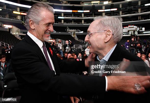 Former Laker coaches Pat RIley greets Bill Sharman at a news conference on the 20th anniversary of Magic Johnson's departure from basketball at...