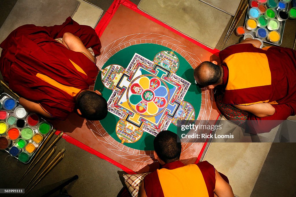 Gaden Jangtse Monks work into a third day creating a sand mandala at the Pacific Asian Museum in Pa