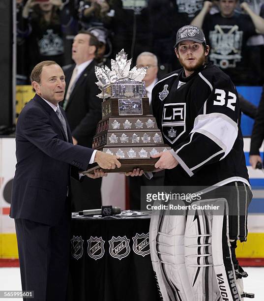Los Angeles Kings goalie Jonathan Quick receives the Conn Smythe trophy from NHL commissioner Gary Bettman after Game 6 of the Stanley Cup Final at...