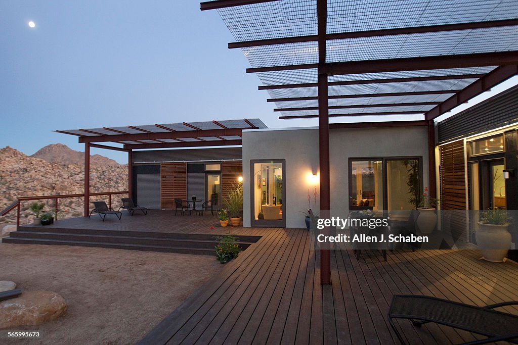 A scenic view of Joshua Tree is viewed from the sitebuilt wood frameliving room connector which c