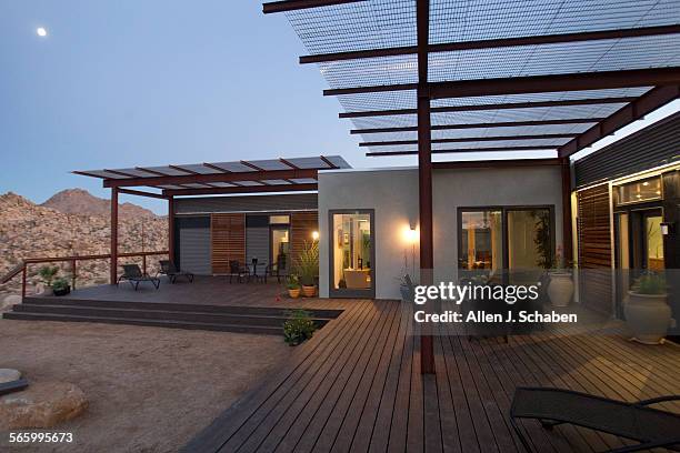 Scenic view of Joshua Tree is viewed from the sitebuilt wood frameliving room connector which connects two 48 feet long, 20 feet wide, 10 feet high...