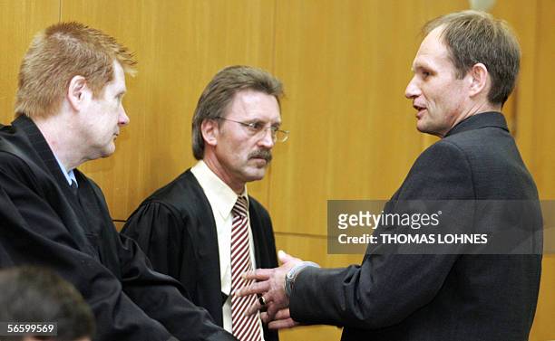 Germany: Germany's self-confessed cannibal Armin Meiwes talks to his lawyers Joachim Bremer and Harald Ermel as he arrives for the second day of his...