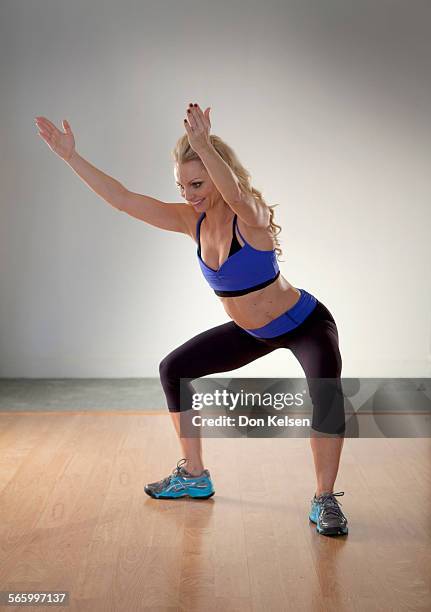   Tracey Mallett demonstrates the Sumo squat with hitcharide .PHOTOGRAPHED TUESDAY FEBRUARY 28, 2012.