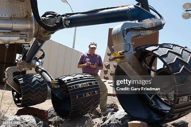 Brian Cooper, lead rover driver for Mars Science Laboratory, tests mobility characteristics of a stripped down model Curiousity rover using a...