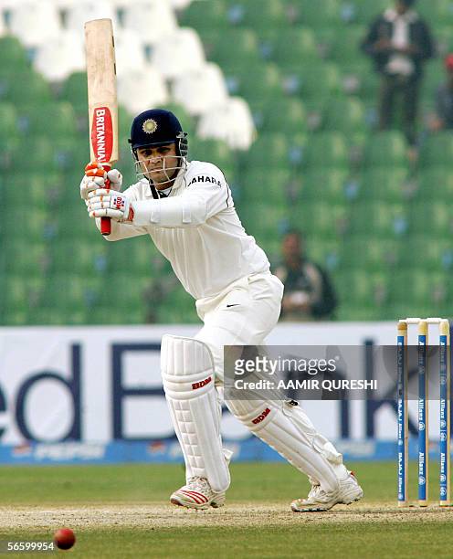 Indian batsman Virender Sehwag plays a boundary off Pakistani spinner Danish Kaneria during the fourth day of the first cricket Test match between...