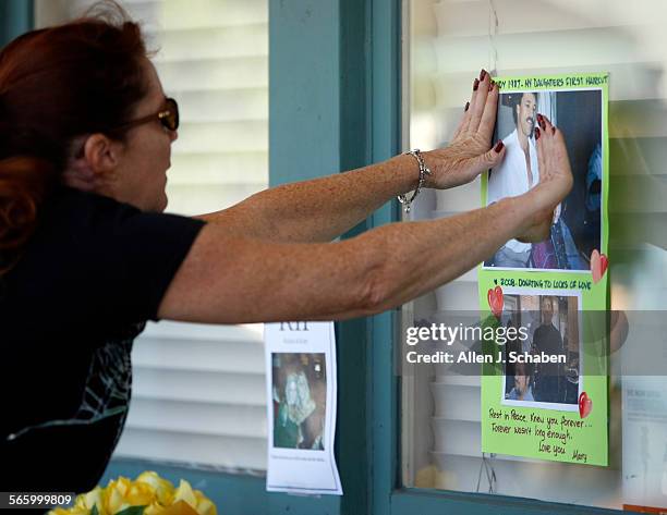 Mary Stearns, of Huntington Beach, posts a photo of her friend, Randy Fannin, the owner of Salon Meritage who is believed to have been killed at his...