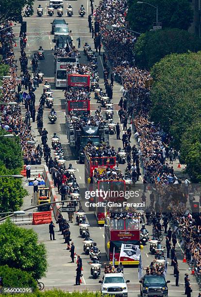 Fans line the parade route as the Stanley Cup champion Los Angeles Kings come through on 5 doubledecker buses on Figueroa Street in downtown Los...