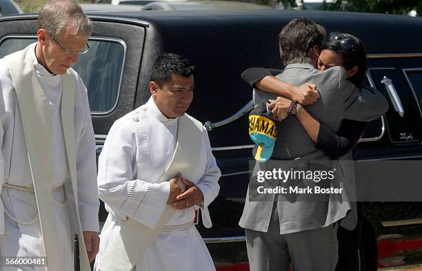 Lasamoa Cross, the girlfriend of mass shooting victim AJ Boik is comforted after his funeral at Queen Of Peace Catholic Church in Aurora, Colorado...