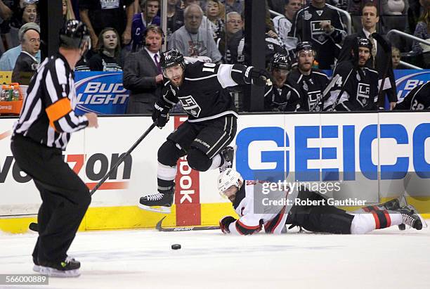 Los Angeles Kings center Mike Richards hops over New Jersey Devils defenseman Andy Greene in the first period of Game 6 of the Stanley Cup Final at...