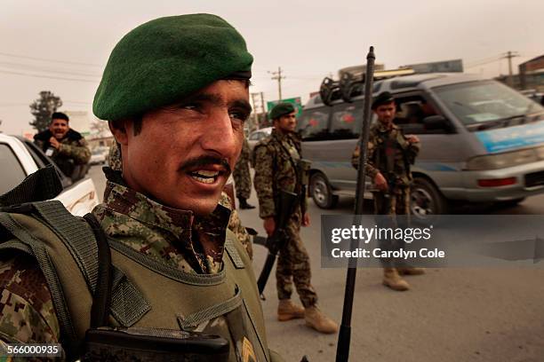 Members of the Afghan National Army, including E5 Wahidullah, left, stand guard near the Kabul International Airport on Dec. 5, 2013. The security...
