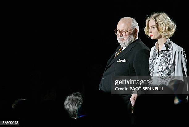 Italian designer Gianfranco Ferre acknowledges the audience with Italian model Eva Riccobono at the end of his show during the Fall / Winter...