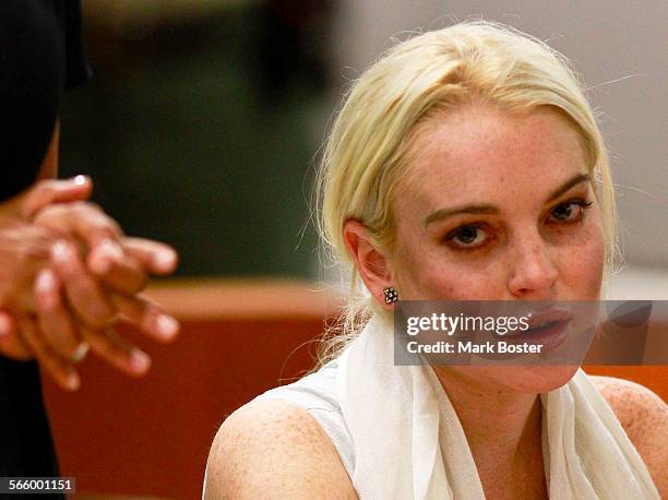 Actress Lindsay Lohan listens to the judge while her attorney Shawn Holley gestures during her probation status hearing in Los Angeles Superior Court...