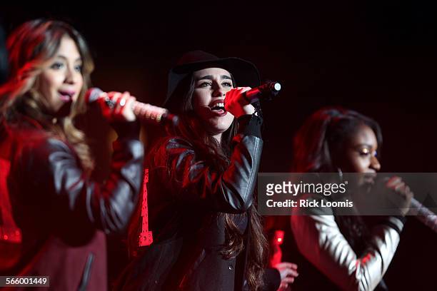 Lauren Jauregui, center, of Fifth Harmony performs with other members of the band at KIIS FM's Jingle Ball 2013 at the Staples Center in Los Angeles.