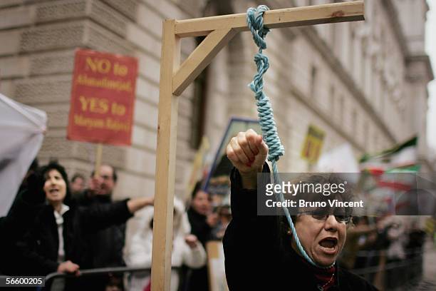 Sedigheh Majidi, a supporter of the National Council of Resistance of Iran simulates her own execution outside the Foreign and Commonwealth Office on...