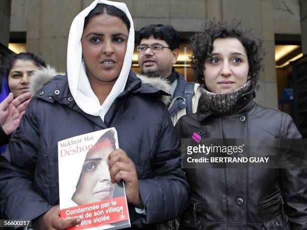 Mukhtar Mai , a Pakistani gang-rape victim poses with her French biography flanked by Sihem Habchi, deputy president of the French association 'Ni...