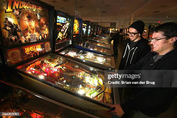 Justin, right, and friend Joey, left, both of whom declined to give their last names, play pinball at the Pinball Hall of Fame in Las Vegas Wednesday...
