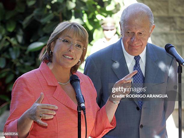 Chile's President Ricardo Lagos listens to President-elect Michelle Bachelet at her house in Santiago, 16 January 2006 before a private meeting....