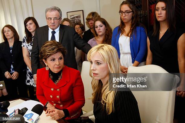 Attorney Gloria Allred, left sitting and Dr. Caroline Heldman, professor of politics, along with 6 sexual assault victims at a news conference to...
