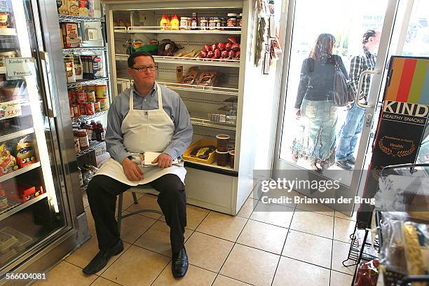 Rabbi Menachem Weiss, left, sits on a chair inside Doheny Glatt Kosher Meats March 29 2012 in Los Angeles. Weiss and his rathe, also a Rabbi, have...