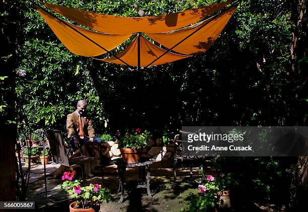 David Schelton an artist and iron worker designed the umbrella in the garden of architect Peter Becker as Becker turned the green room and dressing...