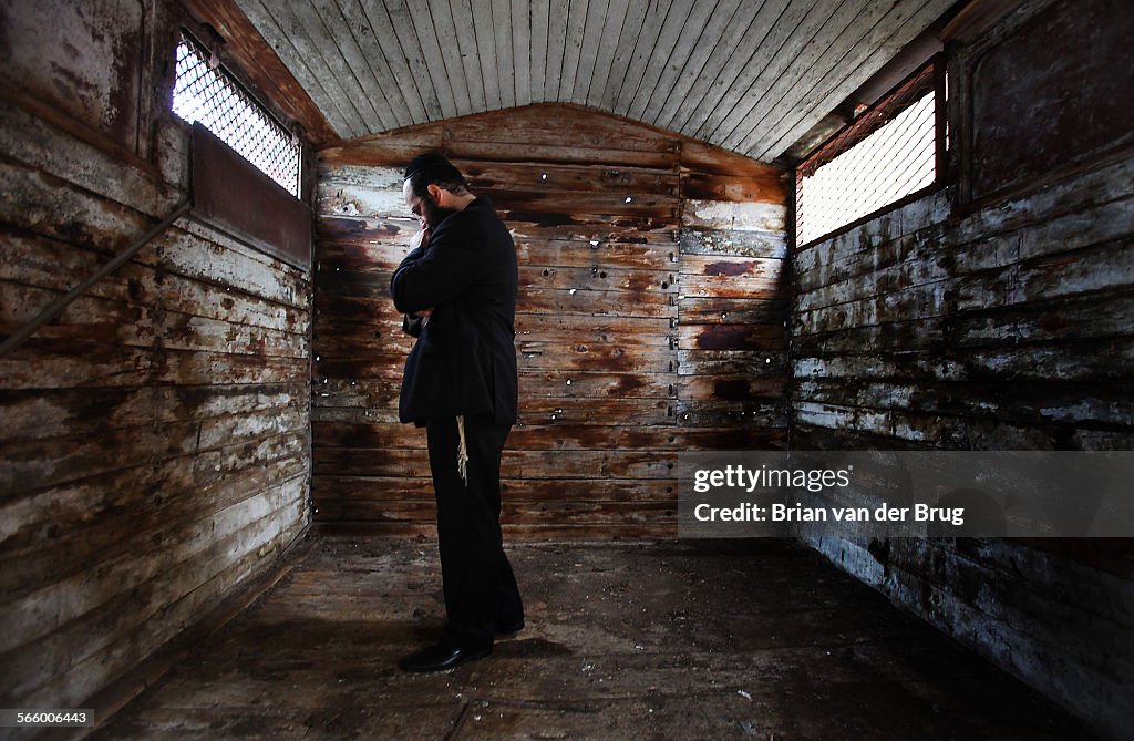 Chabad of the East Valley Rabbi Mendy Deitsch, of Chandler AZ, stands inside a Holocaust era rail c