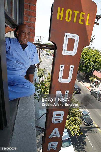 London Carter a disabled veteran, sits in his 5th-floor apartment window overlooking the historic Dunbar Hotel sign at the Dunbar Hotel, on S....