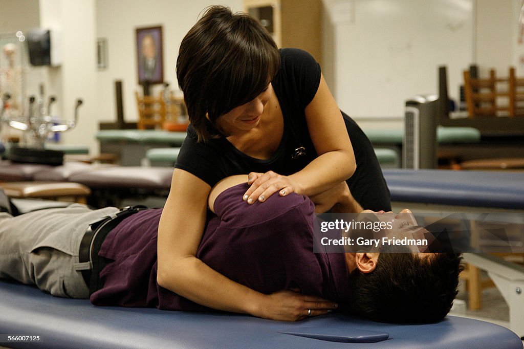 Sarah Fang, a 3rd year osteopathic medical student, does a lumbar roll (adjusting lumbar vertebrae)