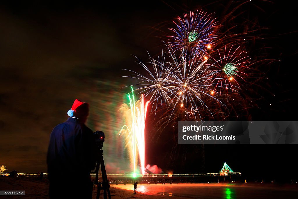 Robert Shellabarger, 41, of Torrance, Ca. gets into the spirit of the season by donning a Santa hat