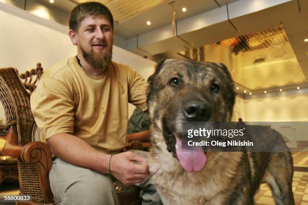 Chechen First Deputy Prime Minister Ramzan Kadyrov plays with his dog in his residence near the village of Centoroy, Chechnya, 3 August 2005. Ramzan...