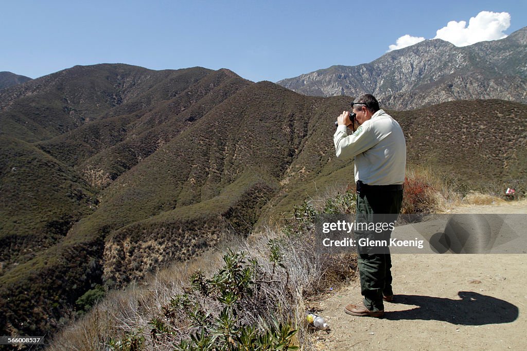 John Miller scans the area for people who have illegally entered Cucamonga Canyon - Sapphire Falls