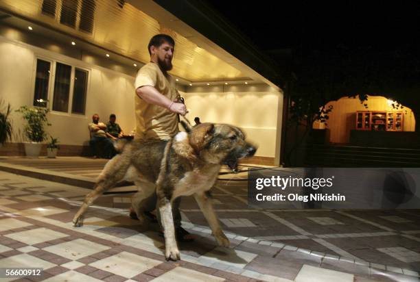 Chechen First Deputy Prime Minister Ramzan Kadyrov plays with his dog in his residence near the village of Centoroy, Chechnya, 3 August 2005. Ramzan...