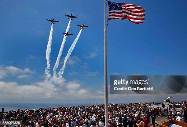 Four WWII-era T-34 planes from the San Diego T-34 Performance Team fly over a crowd of about 2000 people gathered at the Mt. Soledad Veterans...
