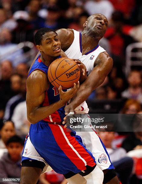 Los Angeles Clippers power forward Lamar Odom collides with Detroit Pistons point guard Brandon Knight while playing tight defense in the first half...