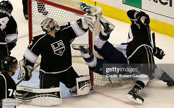 Kings goalie Jonathan Quick knocks the skates out from under Blues forward Jaden Schwartz as he Schwartz looks to score late in the third period in...