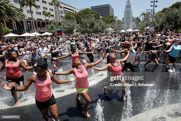 Students at the Fredrick Douglas Academy High School of Los Angeles, front in peach shirts, join dozens taking dance lessons from the modern...