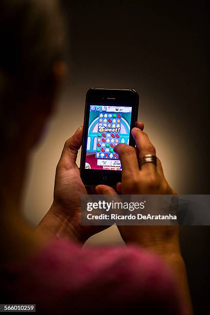 Person playing the Candy Crush Saga game, as beeing photographed in the Los Angeles Times via Getty Images studio, May 16, 2013.