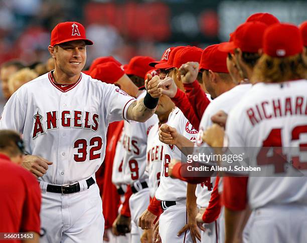 Angels right fielder Josh Hamilton is contratulated by fellow players during the introduction ceremony of the Angels season home opener ceremony...
