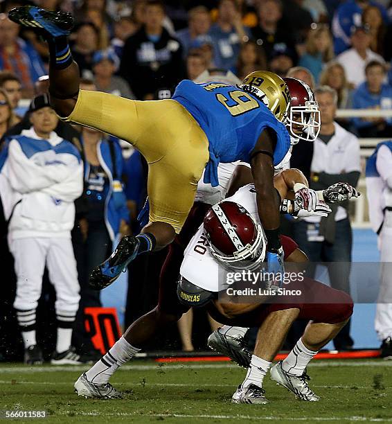 Safety Jayon Brown puts a flying hit on New Mexico State kick returner Adam Shapiro in the second quarter Saturday, Sept. 21 at the Rose Bowl in...