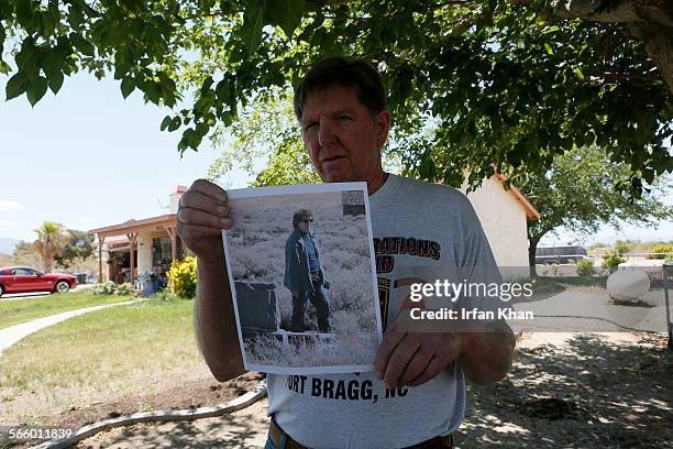 Ben Devitt holds a photo of his wife Pamela who was killed pit bulls on Thursday morning in Littlerock.