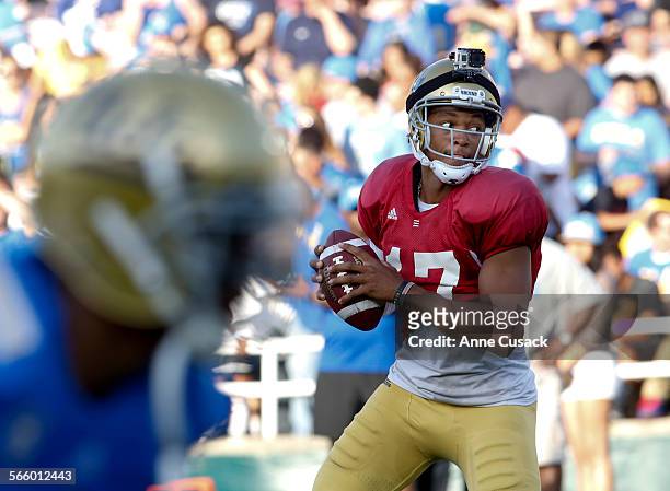 Quarter back Brett Hundley wears a Go Pro camera on his helmet as he looks for a receiver during game action of UCLA spring game at the Rose Bowl in...