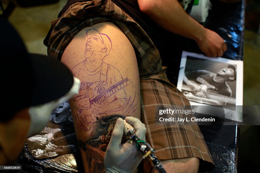 Nathan Arzate,25, from La Puente, has guitarist Tom Morello added to his leg by artist Chente Rios,