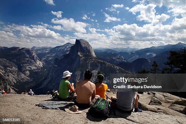 Tourists enjoy the grand view at Glacier Point in Yosemite National Park Aug. 27, 2013 as the Rim fire continues to rage about 25 miles away. Park...