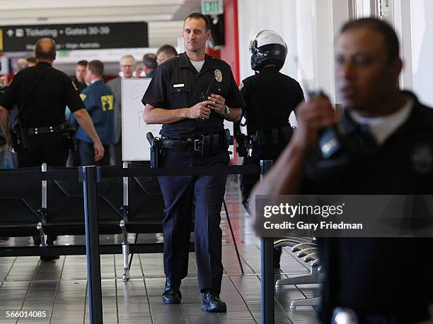 Law enforcement including the FBI, Los Angeles Police Department, Los Angeles Fire Department and LAX AIrport Police gather in Terminal 3 at Los...